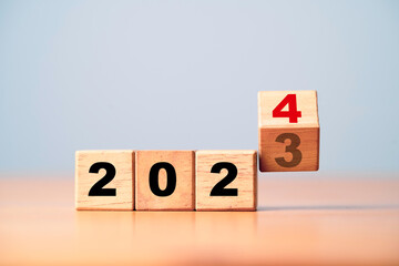 Wall Mural - flipping of 2023 to 2024 on wooden block cube for preparation new year change and start new business