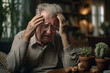 © toonsteb - Sick old man having a headache in the living room during the daytime