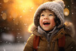 A boy in winter clothes plays in the snow in front of the house
