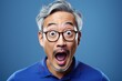 Portrait of surprised middle aged asian woman on bright colors studio backgroud, excitement and fascination, shocked and amazed female with unexpected thing happen