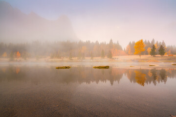 Wall Mural - fall. landscape during sunrise. autumn trees on the river bank. mountains and forest. reflections on