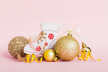 Christmas ball with skates on colored background. decoration bauble with ribbon bow with copy space