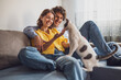 © djoronimo - Portrait of young happy couple and their cat at home.