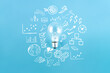 Light bulb and business strategy on blue background. Concept of idea, innovation and Inspiration