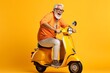 happy mature man riding scooter on yellow color background.