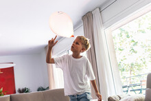 Boy Playing With Balloon At Home