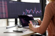 © Westend61 - Businesswoman examining graph on smart phone at desk