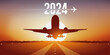 Carte de vœux 2024 pour les compagnies aériennes, montrant un avion qui décolle de la piste d’un aéroport, devant un coucher de soleil.