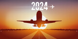 Fototapeta Młodzieżowe - Carte de vœux 2024 pour les compagnies aériennes, montrant un avion qui décolle de la piste d’un aéroport, devant un coucher de soleil.