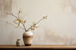 Walls in warm neutrals pair with a blend of Japanese and Scandinavian textiles. A Kintsugi-repaired ceramic vase holds wildflowers, representing the beauty in imperfection