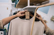 © ADDICTIVE STOCK - Detail of a second hand labeled sweater in retail setting.