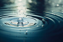 A Drop Of Rain Falling On A Smooth Water Surface.