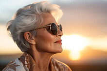 AI Generated Image Of Beautiful Elegant Trendy Elderly Senior Woman Wearing Sunglasses Against The Sunset Sky