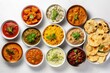 Indian food spread on table including curry samosa biryani dal paneer chapatti naan tikka masala mango lassi Indian dishes for dinner backdrop