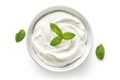 Yogurt cream bowl with basil leaves white background top view