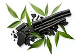 Fototapeta Sypialnia - Top view of isolated activated charcoal with bamboo leaf on white background