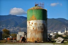 Demolition Works Dilapidated Green Gas Tank Landscape. Gasoline Metal Tank. Generate Ai
