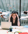 © BullRun - Young disappointed woman feeling headache from deadline surrounded by colleagues at workplace