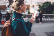 © BullRun - Joyful female tourist with smartphone exploring city