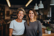 © The other house - Two smiling business owners working in a modern coffee shop. Entrepreneurial businesswomen. Small business couple.