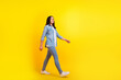Full length photo of nice person with straight hairstyle wear denim jacket pants go shopping to empty space isolated on yellow background