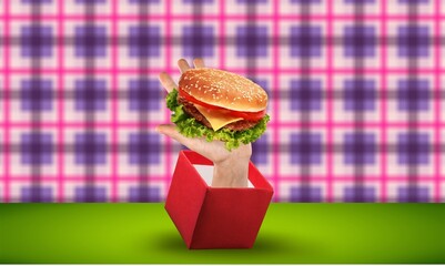 Canvas Print - Human hand sticking from box with burger