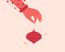 Female Hand Holds Red Xmas Tree Toy. Festive Decoration Ball In Human Arm. Elegant Woman Shares Christmas Bauble. New Year Concept Or Design. Vector Illustration