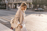 Fototapeta Lawenda - Fashion woman wearing beige coat on the street