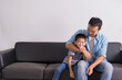 © janonkas - happy asian Father and son are sitting on the couch. Cute boy with dad playing at home. happy family, father day
