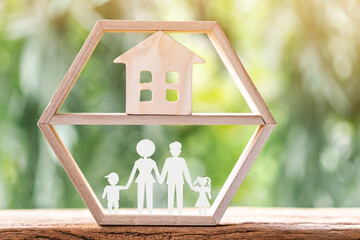 Wall Mural - Wooden family and home model put in the frame wood on the sunlight in the public park, The buy new house or real estate as gift to the one loved concept.