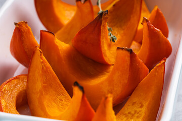 Wall Mural - Roasted pumpkin hokkaido in cooking pan, autumn healthy ingredient