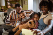 © Marko Geber - Loving young family taking a selfie together on the couch at home