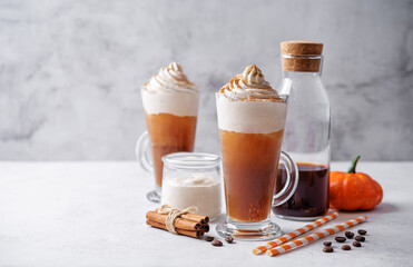 Wall Mural - Pumpkin spice latte with whipped cream and cinnamon in a glass