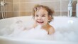 © Irina - Child bathes in a bath with foam.
