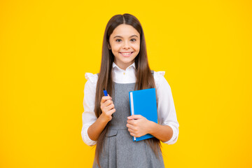 Wall Mural - Back to school. Teenager schoolgirl with book ready to learn. School girl children on isolated yellow studio background.