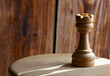 chess piece rook on a wooden board.Rook in chess game