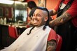 Hispanic man sitting at a barbershop getting haircut smiling