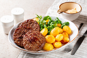 Poster - Homemade dinner. Meat patties with baked potatoes and salad, mayonnaise. Beef Cutlets, burgers or hamburger.