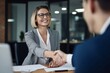© ZenShots Images - Business partners shaking hands over the partnership agreement