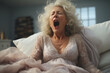 tired yawing woman in white bed in the morning