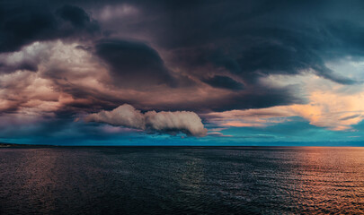 Canvas Print - Dramatic landscape of lake with clouds at sunset, panoramic view