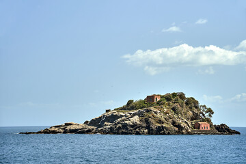 Wall Mural - Rocky islet with historic buildings on the Cyclops coast in Sicily