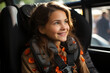 © Degimages - A little girl  sitting in the back seat of a car. Belted in a car