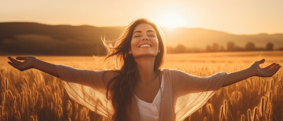 Backlit Portrait of calm happy smiling free woman with open arms and closed eyes enjoys a beautiful moment life on the fields at sunset