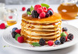 Breakfast pancakes with fresh berries and honey.