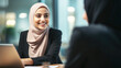 © Melinda Nagy - smiling middle eastern business woman with hijab talking with client