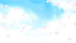 青空に舞う桜の花びらの水彩イラスト