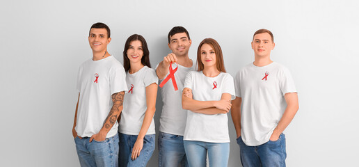 Sticker - Group of people with red ribbons on light background. World AIDS Day