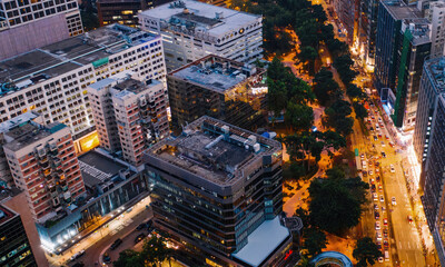 Wall Mural - Aerial top view of downtown district buildings in night city light