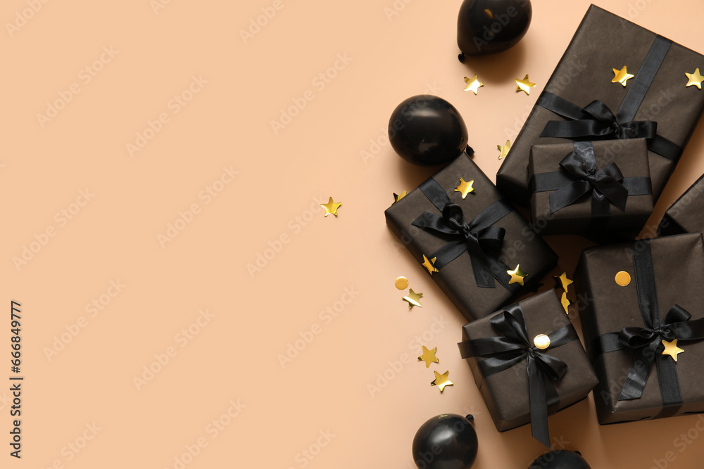 Gift boxes with balloons and confetti on beige background. Black Friday sale